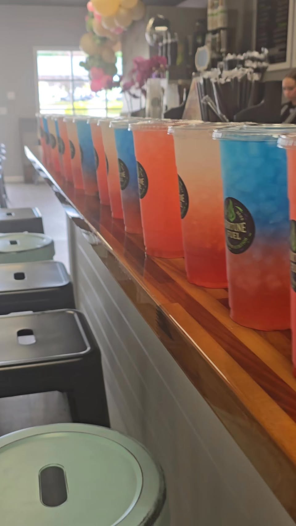 A row of colorful layered energy teas lined up on the counter